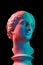 Gypsum copy of ancient statue Venus head  on black background. Plaster sculpture woman face. Multi color toned.