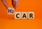 H2 hydrogen car symbol. Businesman hand holds wooden cubes with the word `H2 hydrogen car`. Beautiful orange background, copy