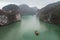 Ha Long, Vietnam. A scenic view on one foggy day of Ha Long Bay and nearby islets viewed from top of Titop island, crowded with