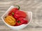 Habanero pepper, jalapeno, capsicum annuum, small spicy peppers in a white bowl, wood background