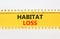 Habitat loss symbol. Concept words Habitat loss on yellow paper. Beautiful yellow table white background. Business habitat loss