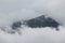 HABITATION IN MOUNTAINS COVERED WITH CLOUDS