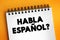 Habla Espanol? text on notepad, concept background