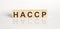 HACCP word from wooden blocks on the white desk