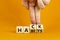 Hack habits symbol. Doctor turns wooden cubes with words `Hack habits`. Beautiful orange table, orange background. Psychology,