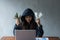 Hacker asia woman stealing data success by using laptop