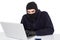 Hacker in balaclava hacking a laptop