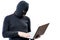 A hacker in black clothes and a mask with a laptop on a white