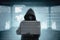 Hacker in black hoodie holding laptop and virtual screen display the server data, binary code, bar graph and world map