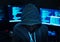 Hacker with computer background and hoody