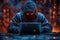 A hacker in a dark blue hoodie sits at a laptop, facing the camera with their face hidden in the style of the hood and