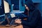 Hacker sitting at laptop, information hacking