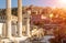 Hadrian`s Library overlooking famous Acropolis at sunset, Athens, Greece. Sunny view of Ancient Greek ruins at Plaka district