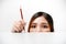 Haft head shot portrait of a girl and holding pencil on white background