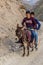 HAFT KUL, TAJIKISTAN - MAY 10, 2018: Boys riding a donkey in Marguzor Haft Kul in Fann mountains, Tajikist