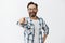 Haha got you. Portrait of carefree funny and emotive handsome mature coworker with beard in checked shirt and glasses