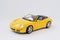 Hai, Ukraine - March 1, 2017: Mini copy of yellow toy car Porsche Carrera S Convertible isolated on white background.