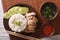 Hainanese chicken rice close-up, chili sauce and broth. horizontal top view
