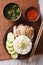 Hainanese chicken rice closeup on a plate. Vertical top view