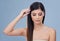 Hair and beauty unmatched. Studio shot of an attractive brunette closing her eyes and holding her hair.