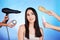 Hair care, beauty and tools with a woman in studio with a hairdryer, self care product and brush. Salon, hairdresser and