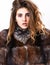 Hair care concept. Girl fur coat posing with hairstyle on white background close up. Prevent winter hair damage. Woman