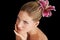 Hair care, flower and woman touch skin, thinking and beauty isolated on a black studio background. Natural, floral