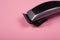 Hair clipper close-up on a pink background. hairdresser tool