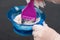 Hair coloring solution in blue mixing bowl
