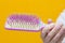 Hair on comb in girl`s hand. Broken hair. Weak and fragile hair concept. Hair fall out. Woman holding comb with hair in hand.