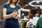 Hair cosmetic. Close up shot of a barber girl or female hairdresser using wax or gel for hair styling while working in