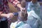 Hair cutting at home for a child. a mother cuts her son`s hair