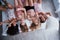 Hair and hands up. Inverted portrait of charming girls that lying on bed in nightwear. Top view