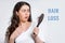 Hair loss. A terrified brunette woman holds a comb in her hands, with a bunch of hair that has fallen out. White background.