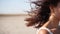 Hair of pretty bride blowing in the wind at desert landscape on the wedding day. Portrait of attractive woman, hair