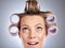 Hair, rollers and beauty with a model woman in studio on a gray background for a hairstyle using curlers. Hair care