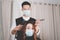 Hair salon concept both male hairstylist and female customer wearing a protective face masks during haircut process