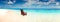 Ð¡hair standing in the sea on the sunlight beach horizontal background