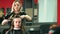 Hair styling in beauty salon. Female customer and hairdresser