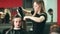 Hair styling in beauty salon. Female customer and hairdresser