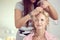 Hair stylist designer making hairstyle for woman