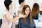 Hair stylist does hair style of woman in hairdressing salon