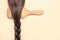 Hairbrush with female brown hair braid.Hairdresser salon and hairstyles concept