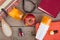 hairbrush, orange towel, sun cream, lotion, beach bag, nail polish, a book on a brown wooden background