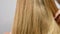 Haircare. Beautiful healthy straight hair. Woman shakes blonde long hair