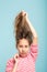 Haircare styling surprised girl hold messy hair