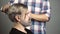 Hairdresser applying colorful tint on man models hair. Advertising and barber shop concept. Professional hairdresser