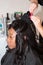 hairdresser artist make wedding hairstyle to charming american black bride woman on wedding day