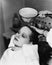 Hairdresser cleaning hair of a young woman in a hair salon