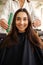 Hairdresser with comb and scissors, woman in salon